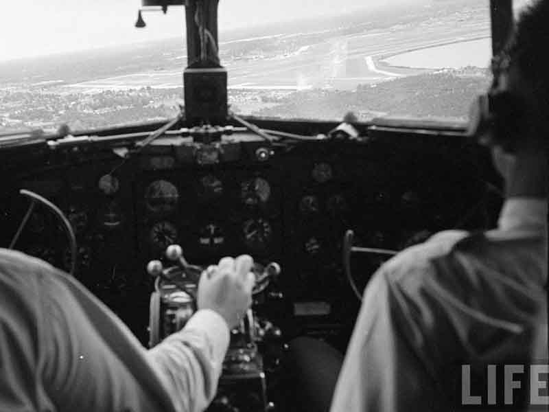 A pilot and copilot view from a Douglas DC-3 aircraft.