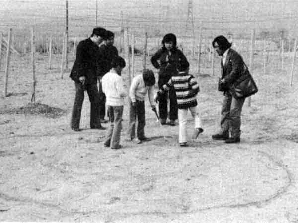 Katsuhiro Yamahata and Masato Kono mark the location where the UFO landed